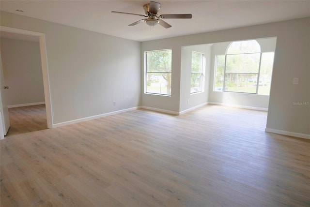 4704 Walden Cir Unit 21, Orlando, FL 32811 - unfurnished room with light wood-type flooring, ceiling fan, and baseboards