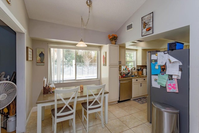 11435 Aries Dr, Orlando, FL 32837 - dining room with vaulted ceiling, light tile patterned floors, and a textured ceiling