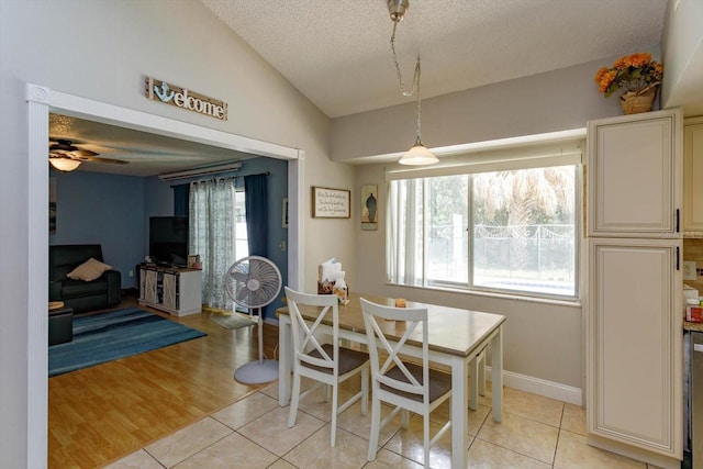 11435 Aries Dr, Orlando, FL 32837 - dining space featuring lofted ceiling, a textured ceiling, ceiling fan, light tile patterned flooring, and baseboards