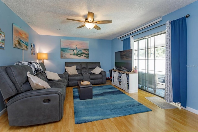 11435 Aries Dr, Orlando, FL 32837 - living room featuring a textured ceiling, ceiling fan, wood finished floors, and baseboards