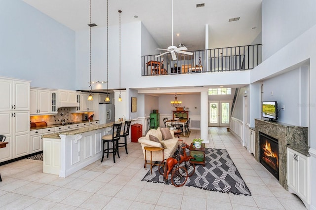 334 N Shadowbay Blvd, Longwood, FL 32779 - living area featuring a towering ceiling, light tile patterned floors, a high end fireplace, and a ceiling fan
