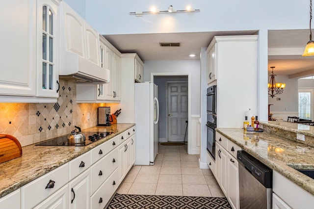 334 N Shadowbay Blvd, Longwood, FL 32779 - kitchen with freestanding refrigerator, black electric cooktop, stainless steel dishwasher, a chandelier, and white cabinetry