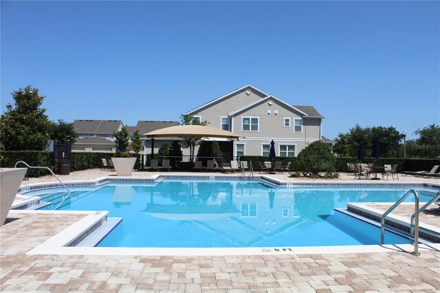 5897 Soter Ln, Windermere, FL 34786 - community pool featuring a patio area and fence