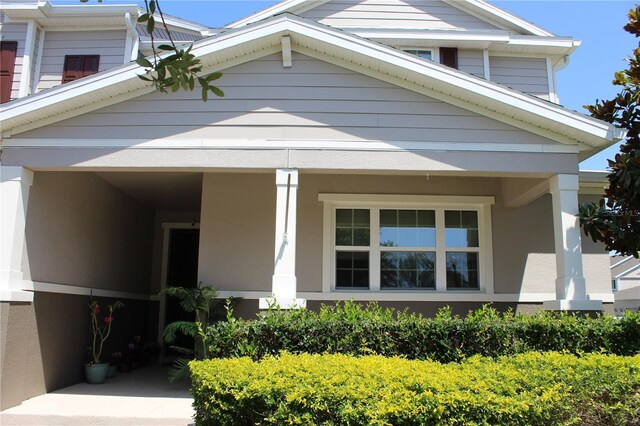 5897 Soter Ln, Windermere, FL 34786 - view of front of house with a porch and stucco siding