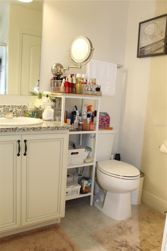 5897 Soter Ln, Windermere, FL 34786 - bathroom featuring toilet, vanity, and tile patterned flooring