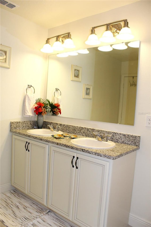 5897 Soter Ln, Windermere, FL 34786 - bathroom featuring double vanity and baseboards