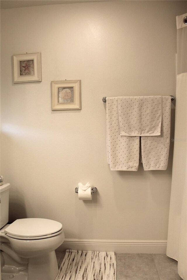 5897 Soter Ln, Windermere, FL 34786 - bathroom with baseboards, toilet, and tile patterned flooring