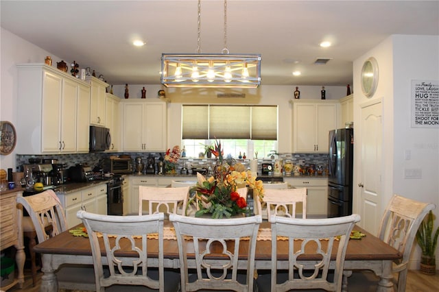 5897 Soter Ln, Windermere, FL 34786 - kitchen with black appliances, tasteful backsplash, decorative light fixtures, recessed lighting, and dark countertops