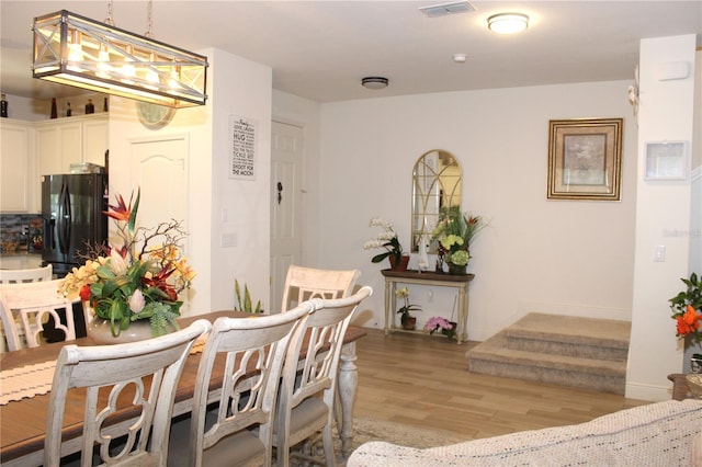 5897 Soter Ln, Windermere, FL 34786 - dining area with light wood-type flooring, baseboards, and a chandelier