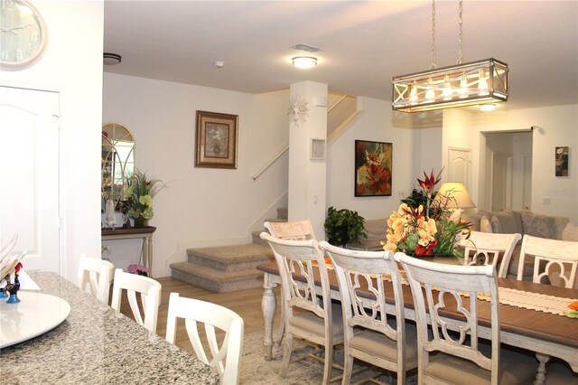 5897 Soter Ln, Windermere, FL 34786 - dining area with stairs and light wood-type flooring
