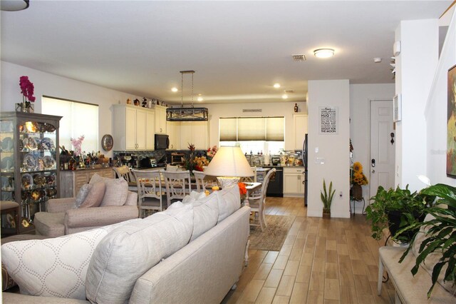 5897 Soter Ln, Windermere, FL 34786 - living room featuring light wood-style flooring and recessed lighting