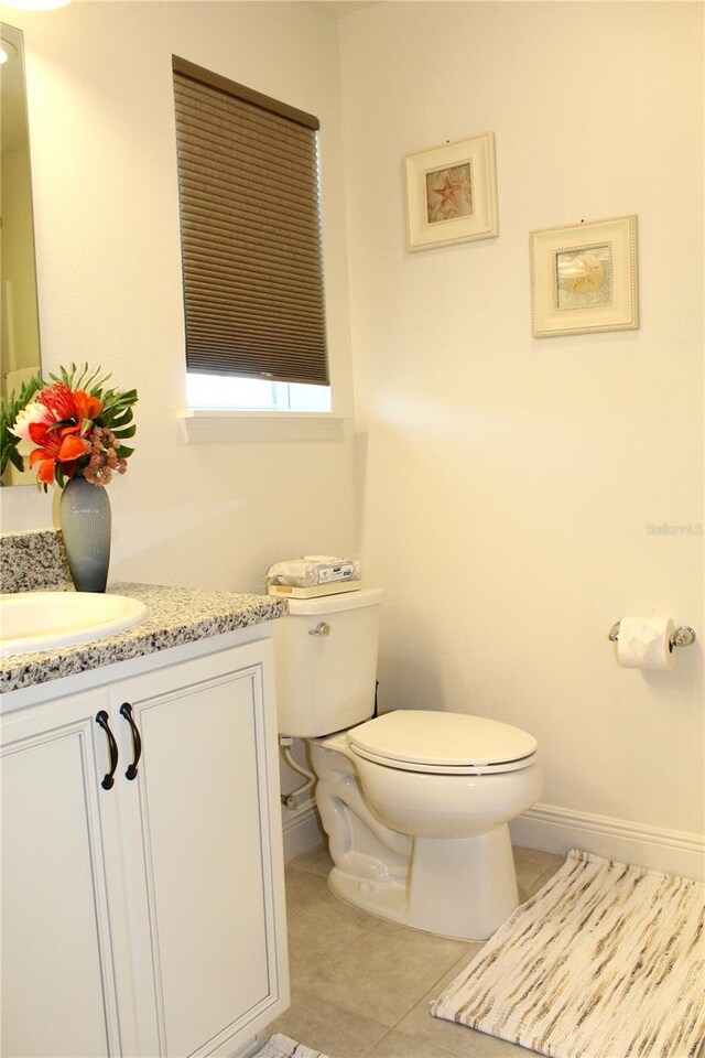 5897 Soter Ln, Windermere, FL 34786 - half bathroom with toilet, tile patterned floors, vanity, and baseboards
