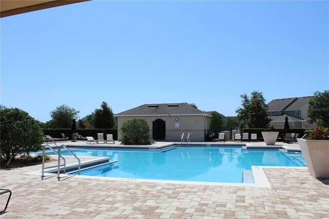 5897 Soter Ln, Windermere, FL 34786 - community pool with a patio and fence