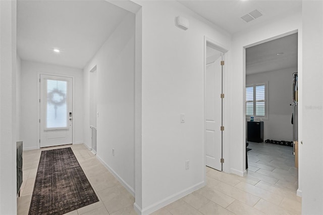 entrance foyer featuring light tile patterned floors, recessed lighting, and baseboards