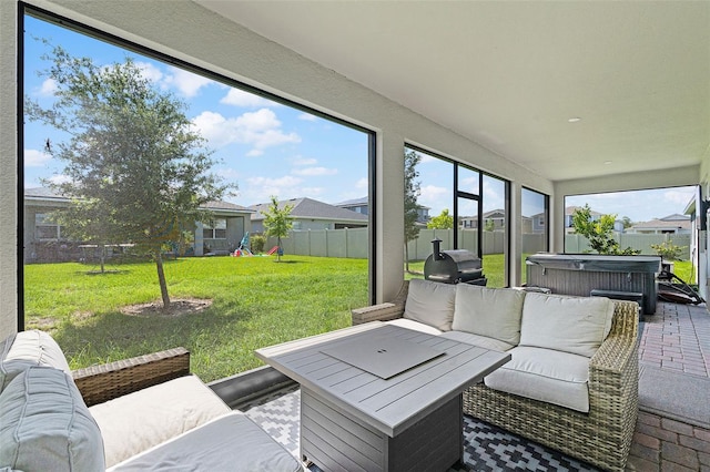 sunroom / solarium featuring a hot tub and an outdoor living space