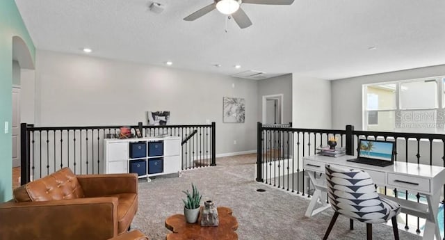 7876 Marlow Pl, Kissimmee, FL 34747 - living area featuring an upstairs landing, ceiling fan, carpet flooring, baseboards, and arched walkways