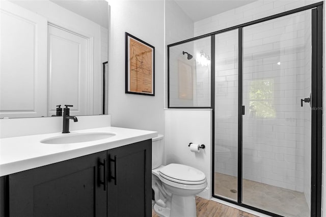 8460 Sperry St, Orlando, FL 32827 - bathroom featuring vanity, wood finished floors, a stall shower, and toilet