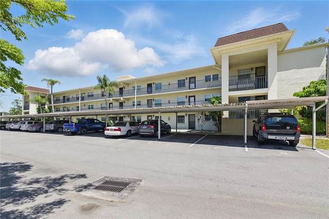 1415 Doolittle Ln Unit 106, Dunedin, FL 34698 - view of building exterior with covered parking