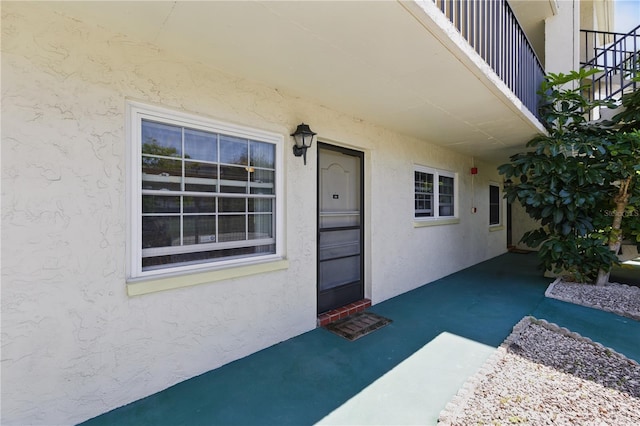 1415 Doolittle Ln Unit 106, Dunedin, FL 34698 - view of exterior entry with stucco siding
