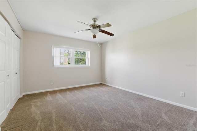 1415 Doolittle Ln Unit 106, Dunedin, FL 34698 - unfurnished bedroom featuring carpet floors, a closet, baseboards, and ceiling fan