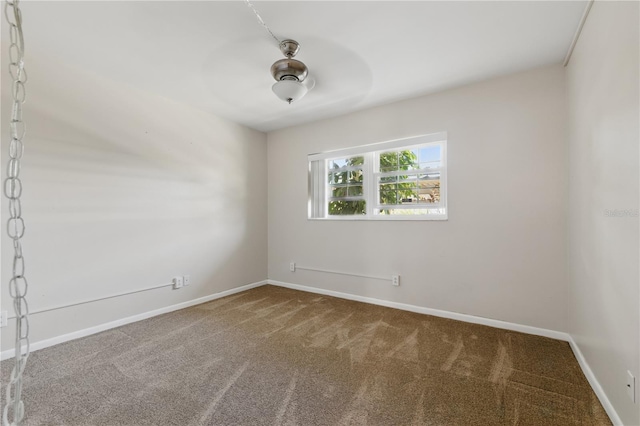1415 Doolittle Ln Unit 106, Dunedin, FL 34698 - spare room featuring carpet floors and baseboards