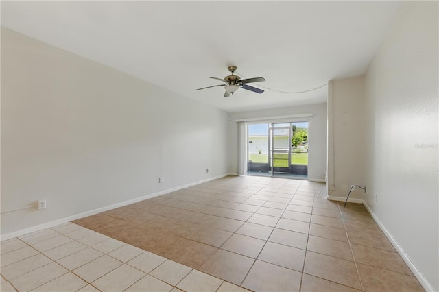1415 Doolittle Ln Unit 106, Dunedin, FL 34698 - spare room featuring light tile patterned floors, a ceiling fan, and baseboards