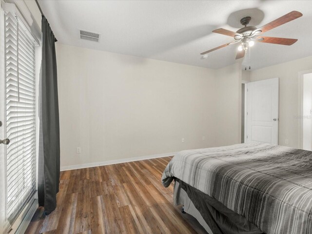 10247 Mason Loop, Clermont, FL 34711 - bedroom featuring wood finished floors, baseboards, and a ceiling fan