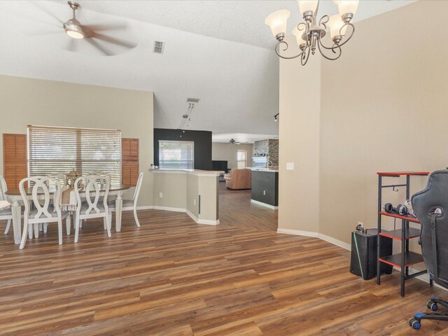 10247 Mason Loop, Clermont, FL 34711 - dining area with ceiling fan, wood finished floors, a chandelier, baseboards, and lofted ceiling