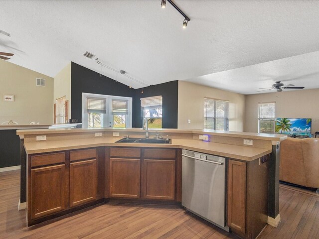 10247 Mason Loop, Clermont, FL 34711 - kitchen with open floor plan, a sink, stainless steel dishwasher, a ceiling fan, and light countertops