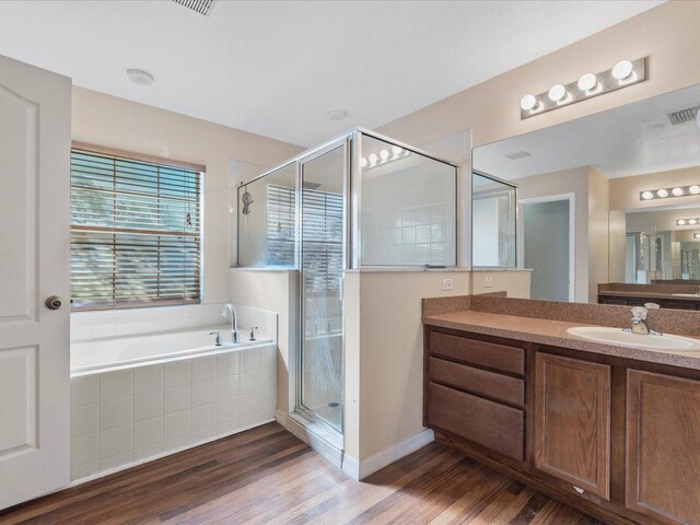 10247 Mason Loop, Clermont, FL 34711 - bathroom with a stall shower, wood finished floors, vanity, and a garden tub