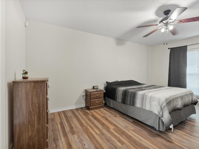 10247 Mason Loop, Clermont, FL 34711 - bedroom featuring wood finished floors, baseboards, and a ceiling fan