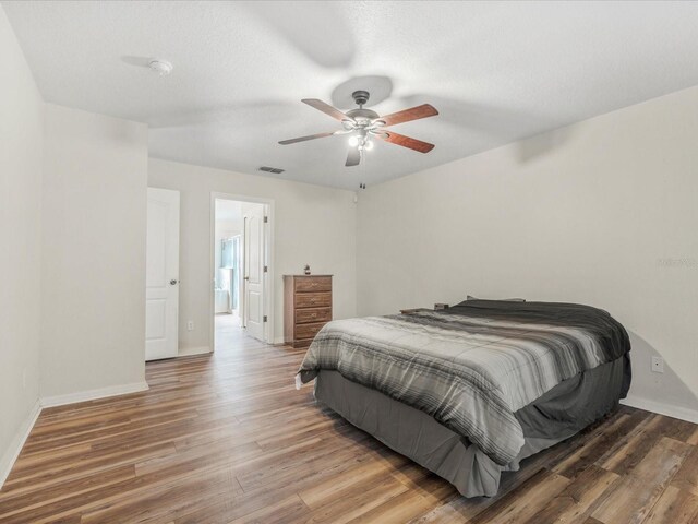 10247 Mason Loop, Clermont, FL 34711 - bedroom with wood finished floors, baseboards, and a ceiling fan