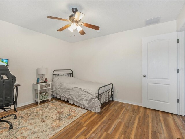 10247 Mason Loop, Clermont, FL 34711 - bedroom with wood finished floors, baseboards, and a ceiling fan