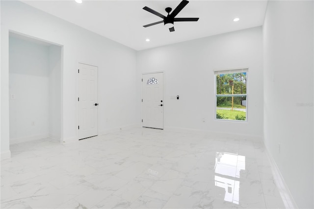 spare room with ceiling fan, baseboards, recessed lighting, and light marble finish floors
