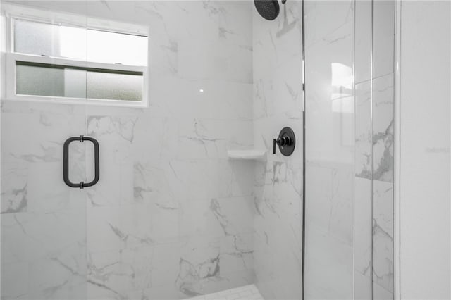 full bathroom featuring a marble finish shower