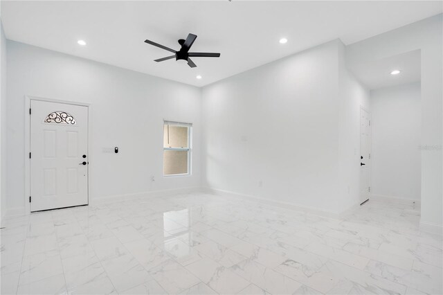 empty room featuring a ceiling fan, recessed lighting, baseboards, and light marble finish floors
