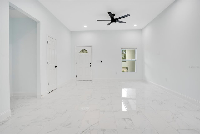 unfurnished room featuring ceiling fan, baseboards, recessed lighting, and light marble finish floors
