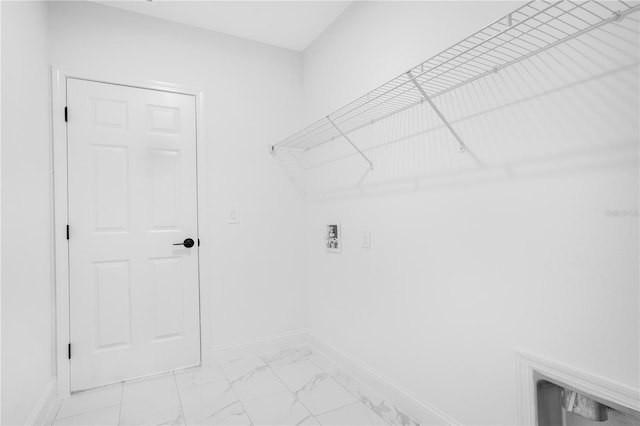 laundry area with light marble finish flooring, baseboards, and hookup for a washing machine