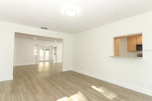 1204 Duncan Ct, Longwood, FL 32779 - unfurnished room with light wood-style flooring, baseboards, and french doors