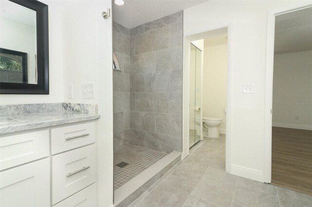 1204 Duncan Ct, Longwood, FL 32779 - bathroom featuring a walk in shower, toilet, vanity, baseboards, and tile patterned floors