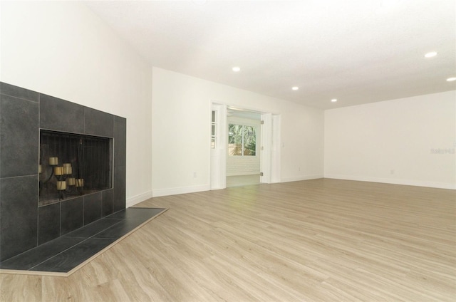 1204 Duncan Ct, Longwood, FL 32779 - unfurnished living room with wood finished floors, recessed lighting, and a tile fireplace