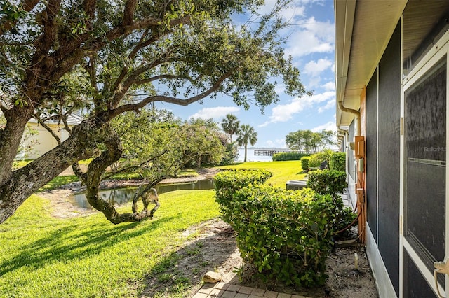 view of grassy yard with a water view
