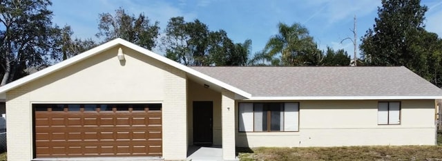 622 N Goodrich Dr, Deltona, FL 32725 - single story home with a garage, a shingled roof, and brick siding