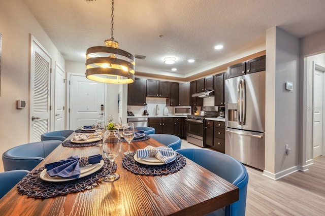 4013 Breakview Dr Unit A407, Orlando, FL 32819 - dining area with light wood-style floors, baseboards, recessed lighting, and a textured ceiling