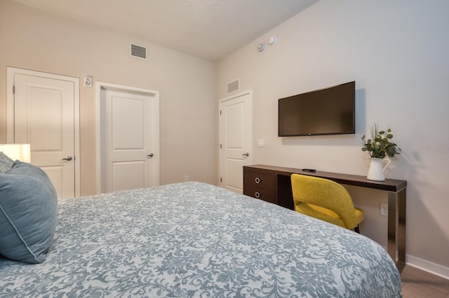 4013 Breakview Dr Unit A407, Orlando, FL 32819 - bedroom featuring baseboards, wood finished floors, and a textured ceiling