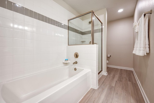 4013 Breakview Dr Unit A407, Orlando, FL 32819 - full bathroom with wood finished floors, a garden tub, a stall shower, baseboards, and recessed lighting