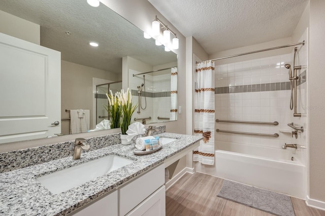 4013 Breakview Dr Unit A407, Orlando, FL 32819 - bathroom featuring wood finished floors, shower / tub combo, a textured ceiling, and double vanity