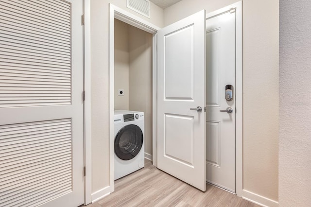 4013 Breakview Dr Unit A407, Orlando, FL 32819 - clothes washing area with washer / clothes dryer, light wood-style floors, and baseboards