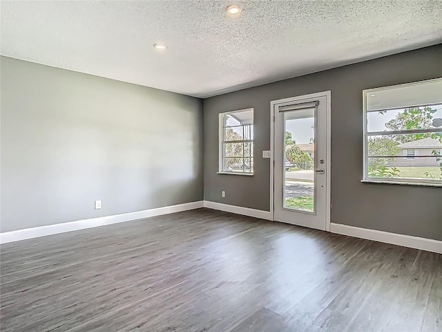 8228 Shriver Dr, Orlando, FL 32822 - unfurnished room featuring dark wood-style floors, a textured ceiling, baseboards, and recessed lighting