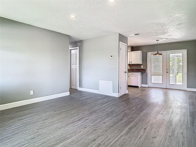 8228 Shriver Dr, Orlando, FL 32822 - unfurnished living room with a textured ceiling, dark wood-style floors, baseboards, and recessed lighting